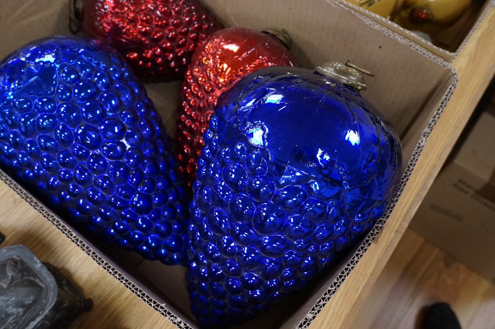A collection of coloured circular and grape shaped glass witches balls and decorations, largest grape decoration 40cm in length